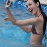 Coraleen Waddell taking a selfie in a bikini