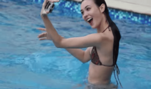 Coraleen Waddell taking a selfie in a bikini